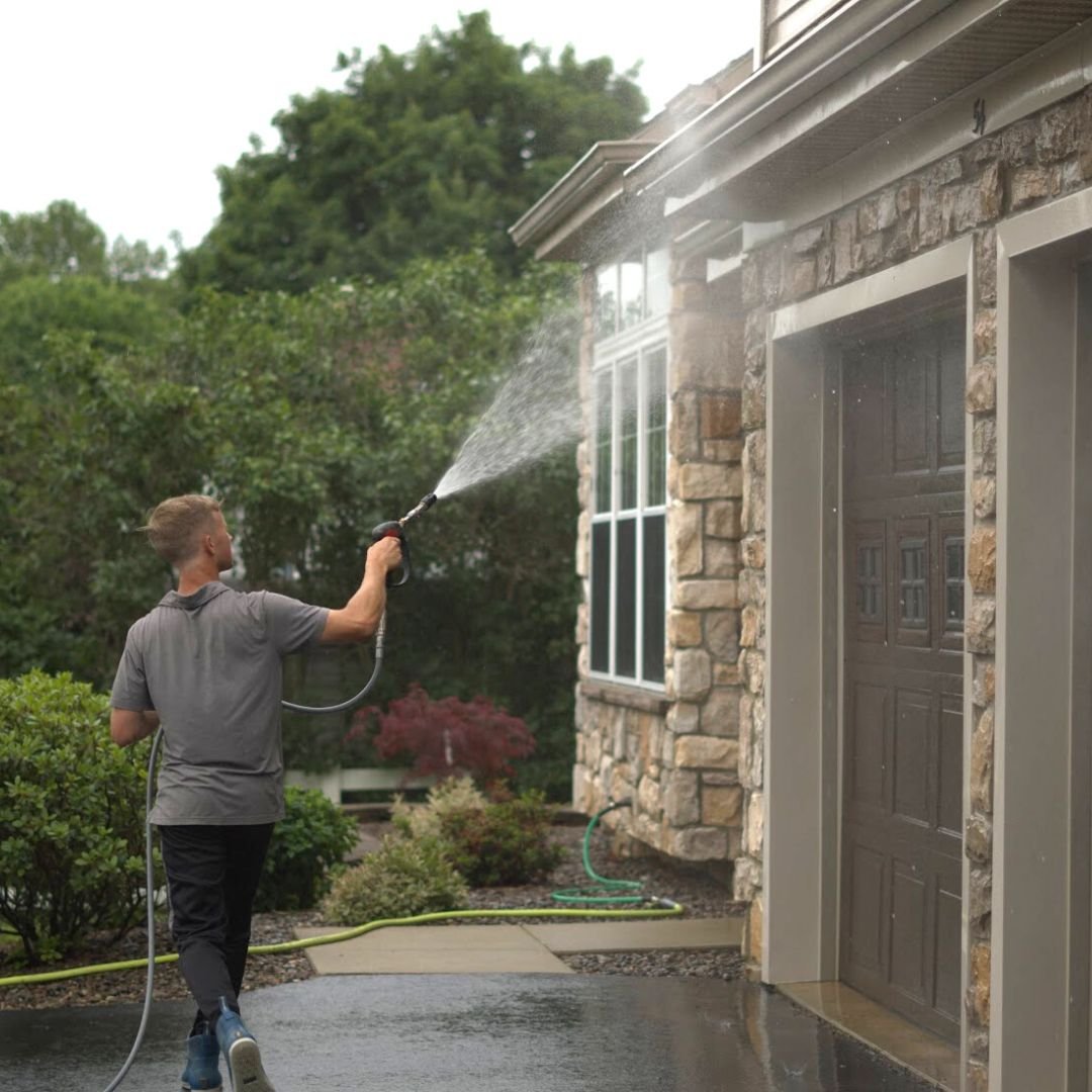 Local Boys pressure washing a home exterior